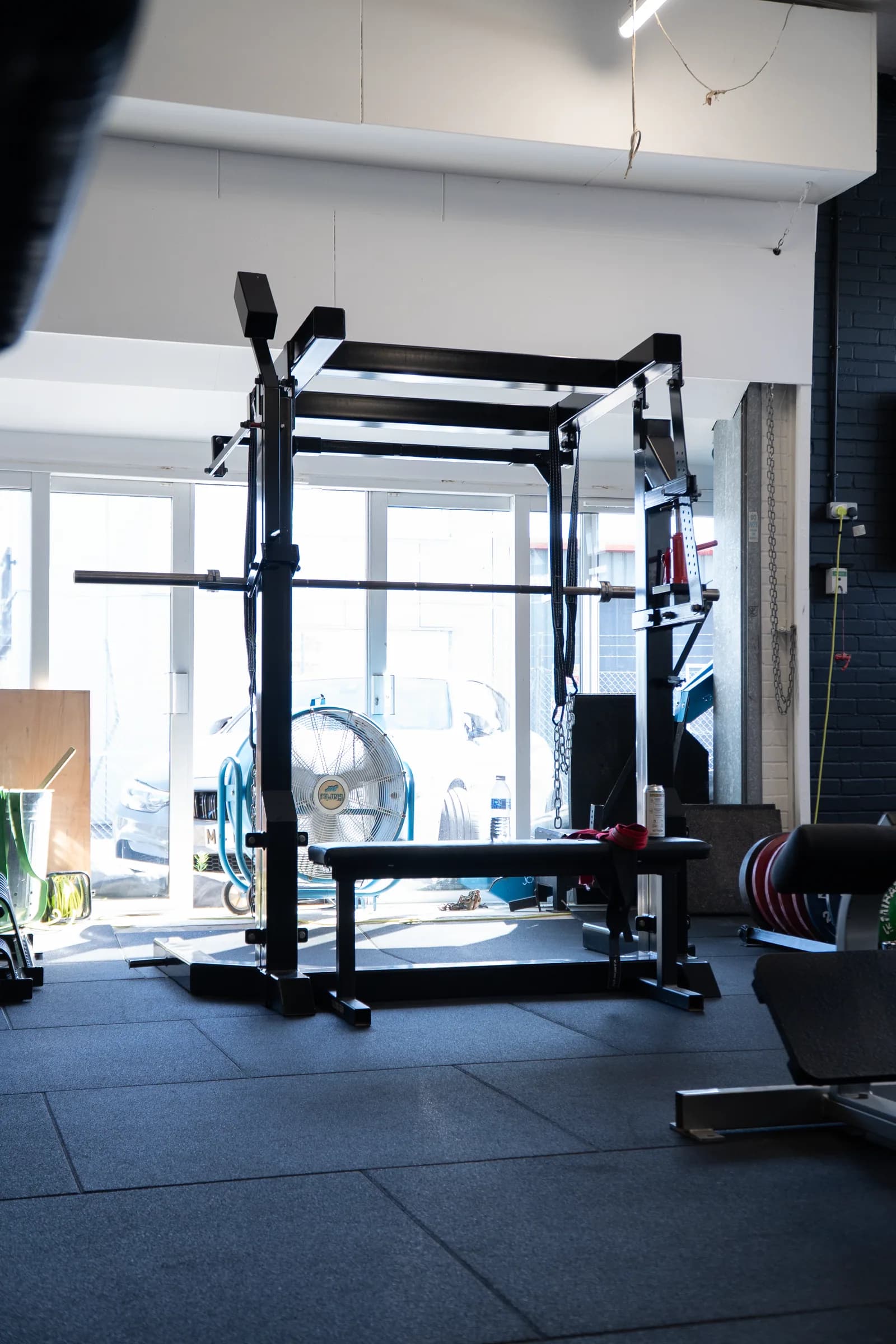 Barbell rack and bench in the strength area at VK Gym.