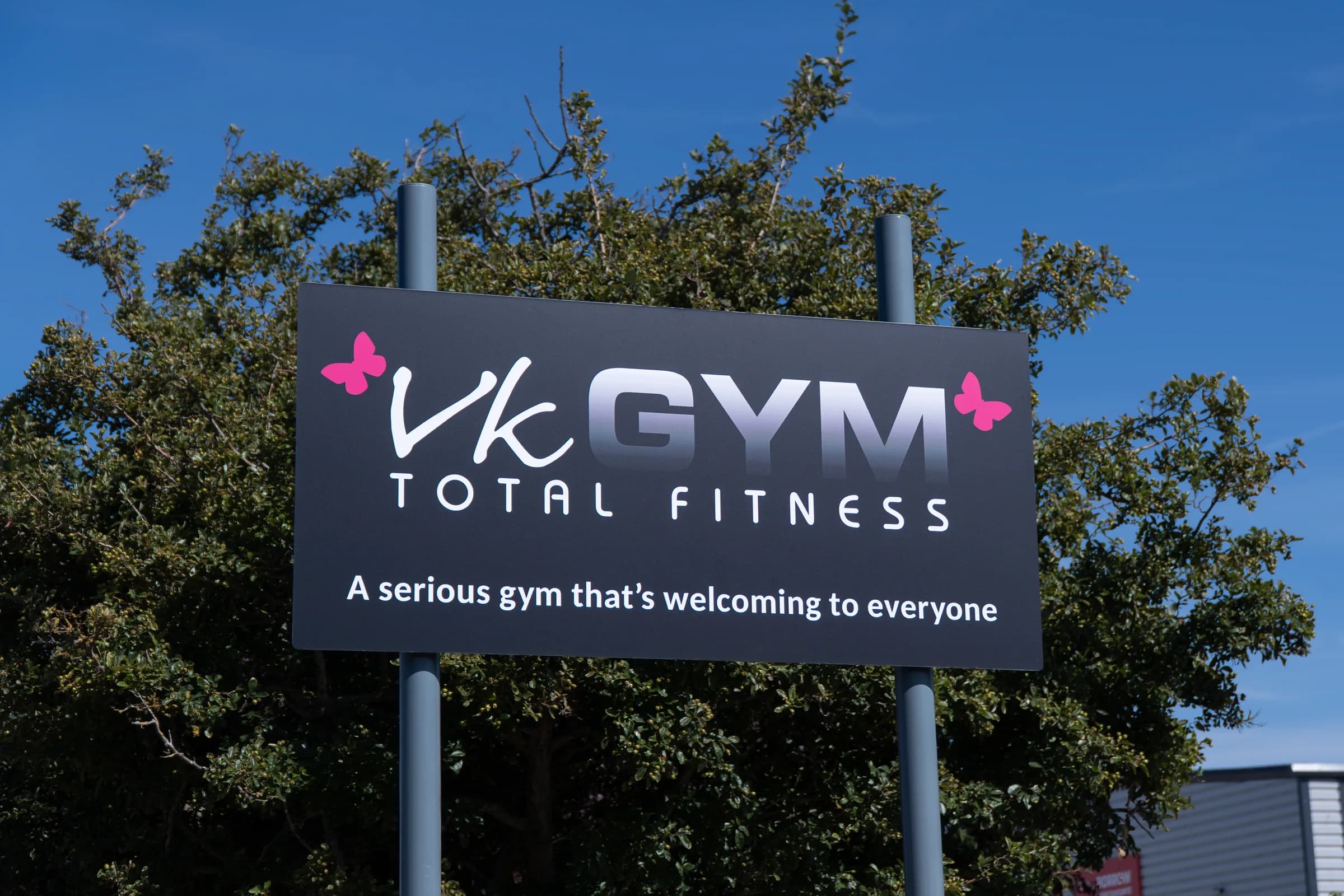 VK Gym Total Fitness sign reading “A serious gym that’s welcoming to everyone”.